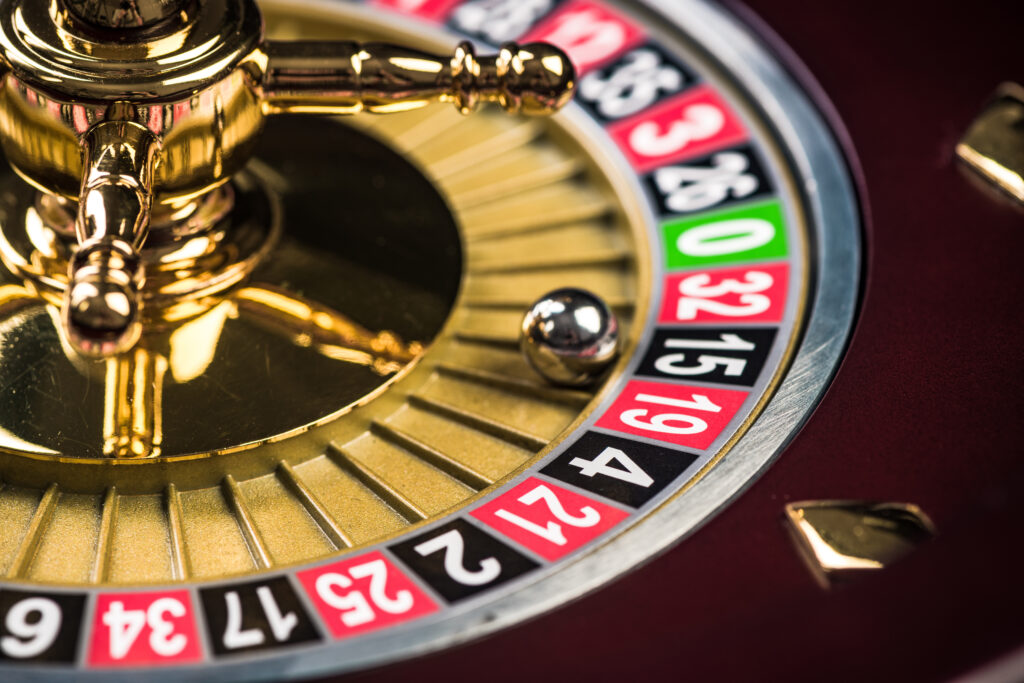 Close up of a roulette wheel with a silver ball on the number 15.