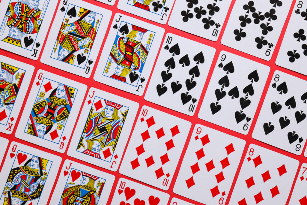 Playing cards on a red table.