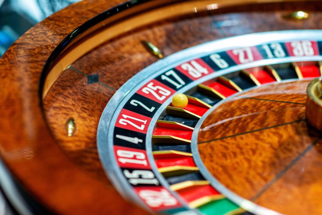 Close up of a roulette wheel with a yellow ball on the number 25.