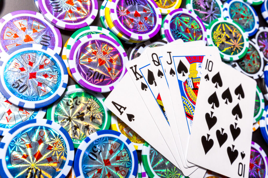 A Full House of playing cards on top of colourful casino chips.
