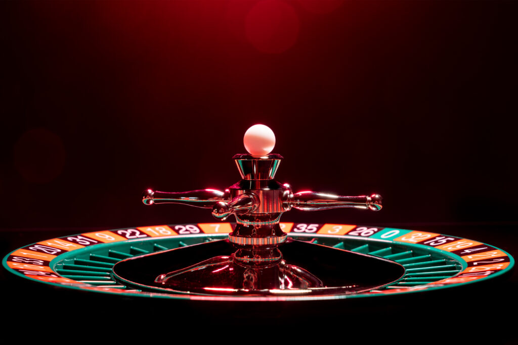 Roulette wheel with white ball on its top.