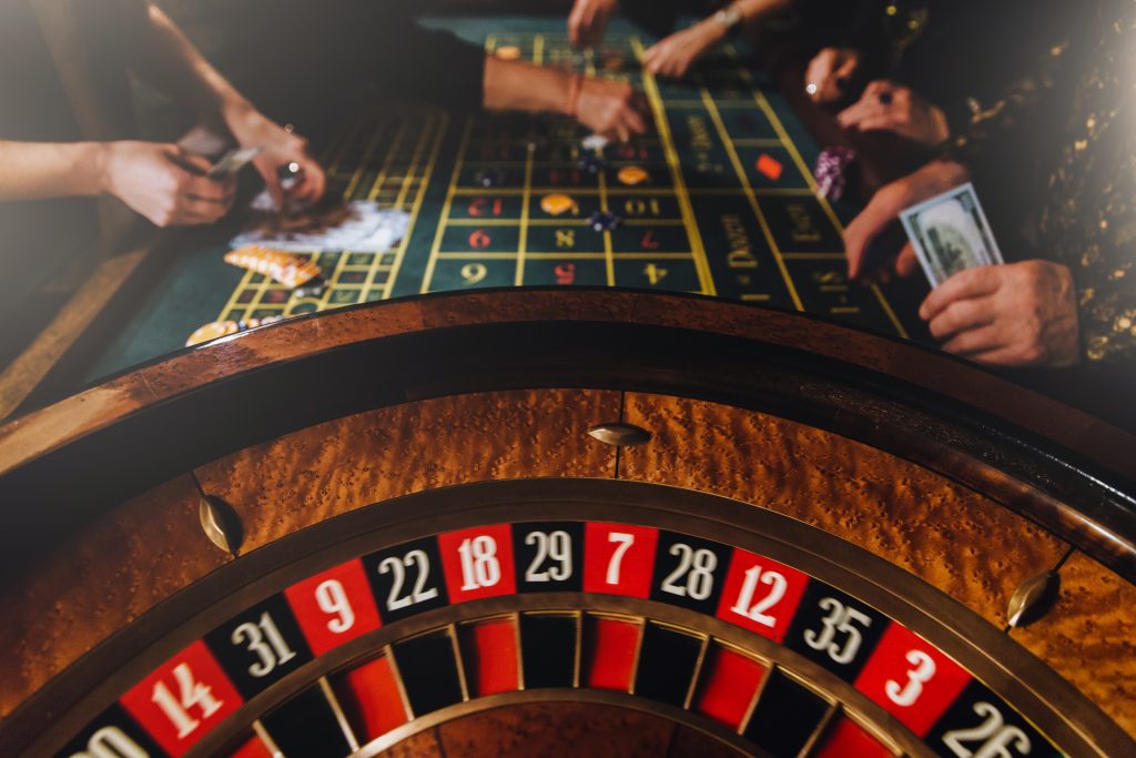 A photo of a roulette wheel with the roulette table in the background.