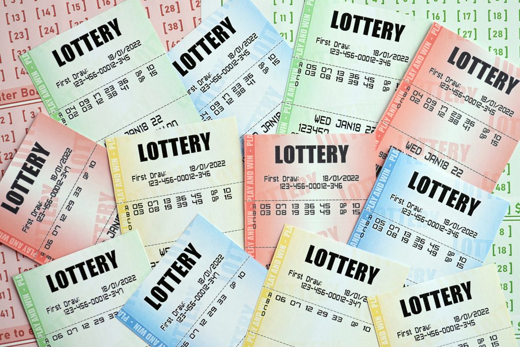 A photo of many different coloured lottery tickets stacked on top of each other.