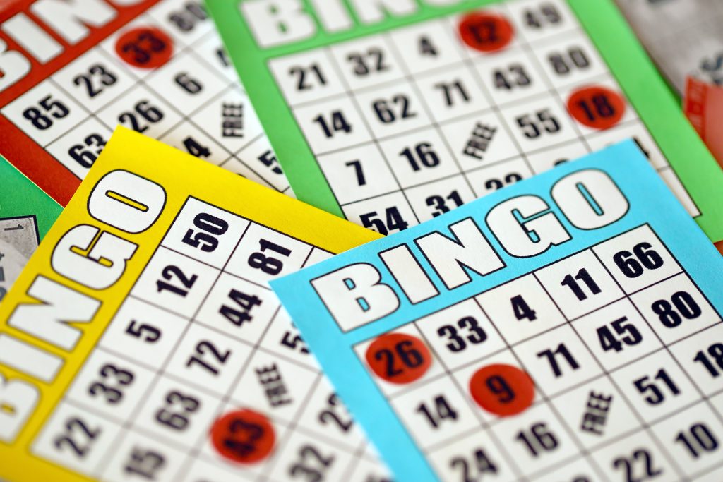 A photo of several bingo cards of different colours.