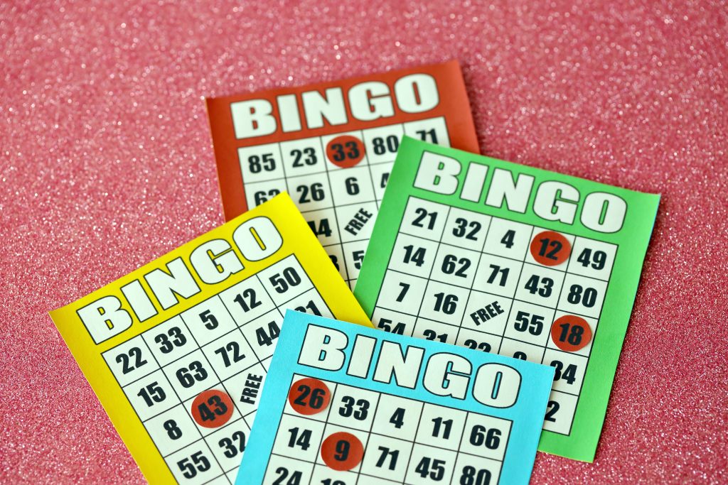 A photo of multiple bingo cards of different colours.