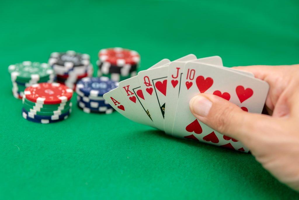A photo of a person holding a Royal Flush in their poker hand.