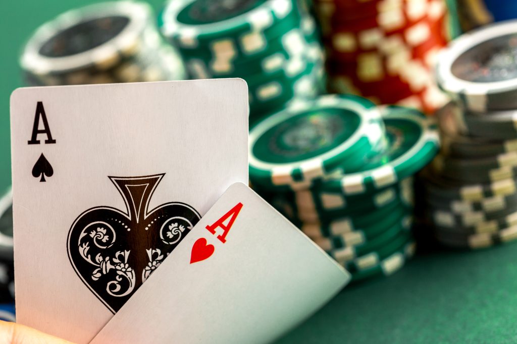 A photo of two Aces next to casino chips.