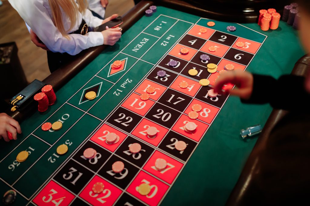 A photo of players placing bets on a roulette table.