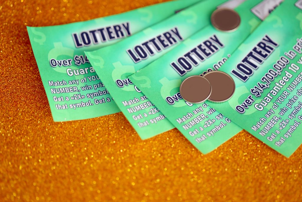 A close up photo of four green scratch cards.