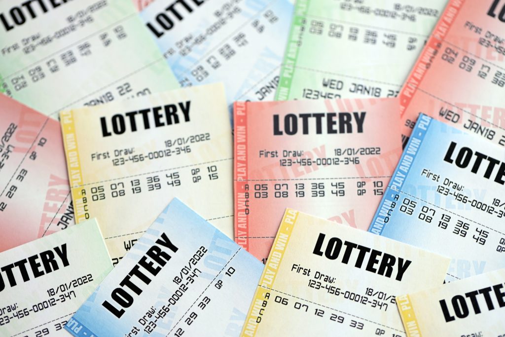 A close up photo of several lottery tickets in different colours.