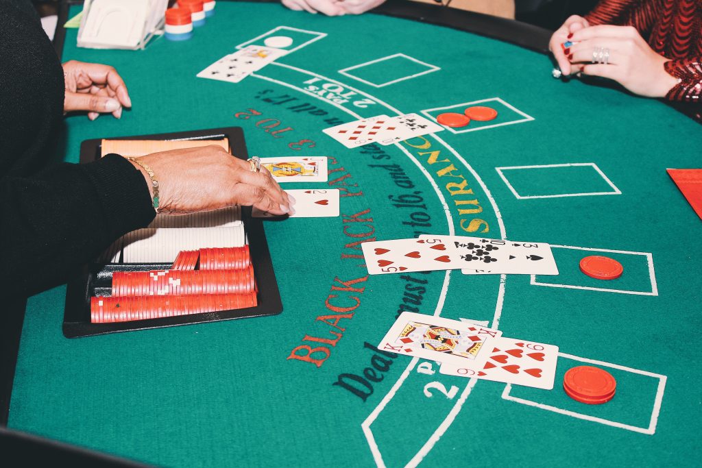 A photo of a blackjack dealer dealing cards to the table.
