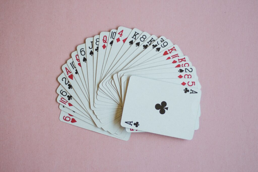 Playing cards on a pink background.