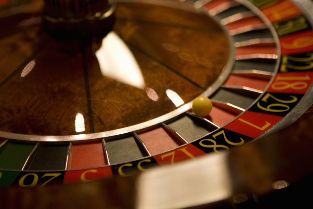 Close up of a roulette wheel with the ball on 7.